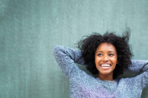 A woman smiling with a blue background
